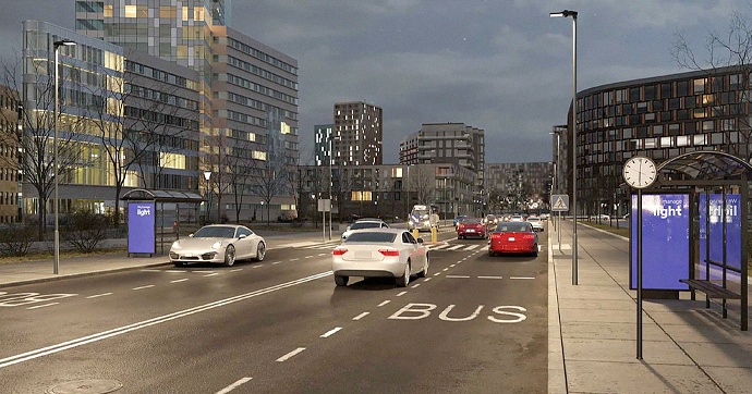 Iluminação pública inteligente numa rua urbana com carros em circulação durante a noite